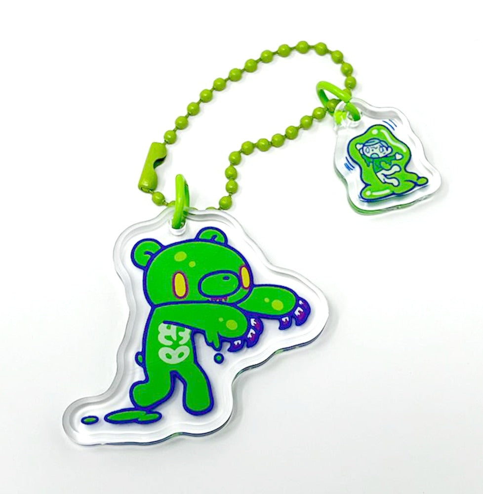 Green cartoon character charm with a beaded strap on a white background