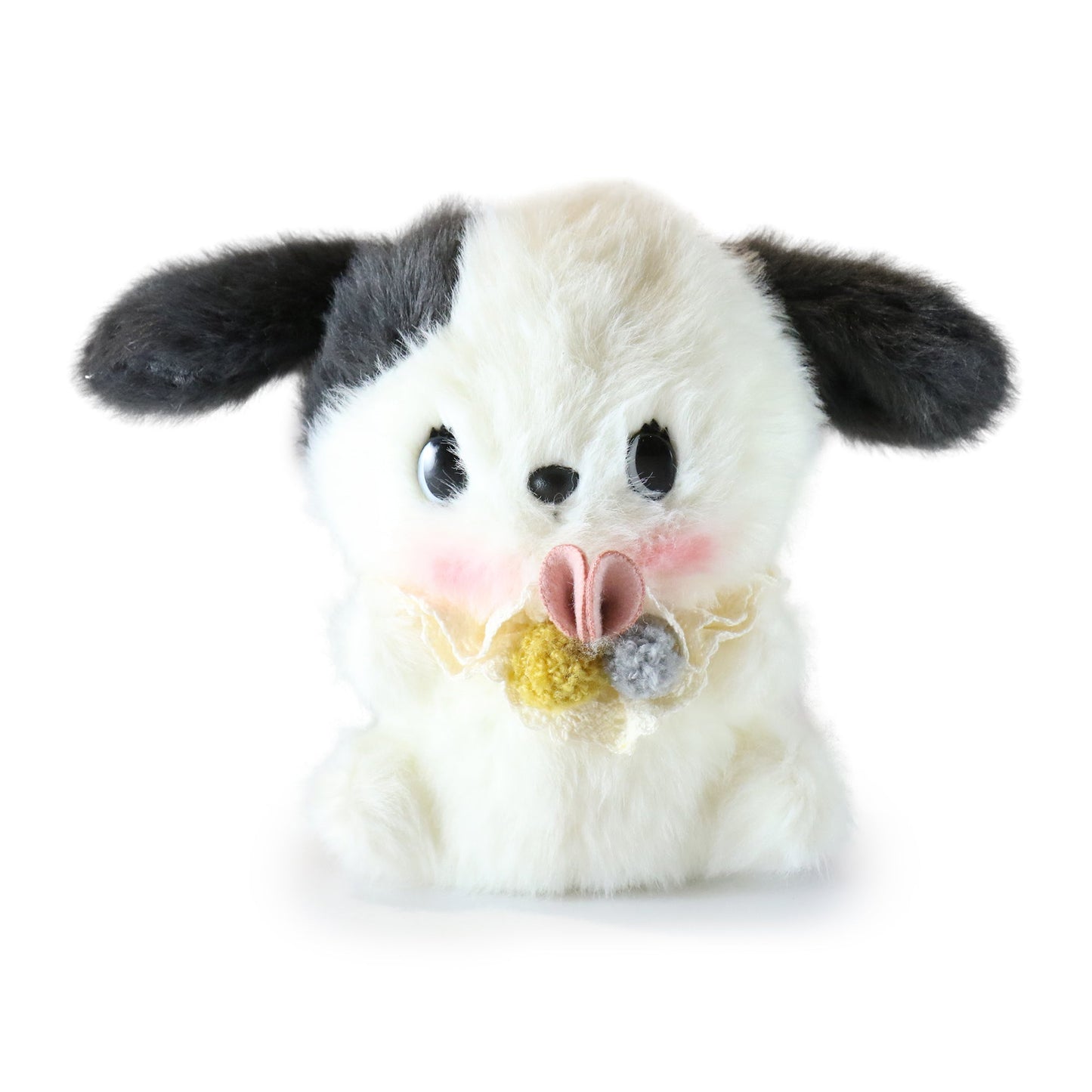 Black and white dog plush toy with a flower bow on a white background