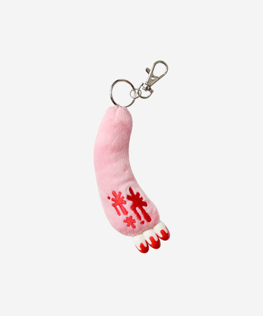 Pink foot-shaped keychain with red snowflake designs on a white background