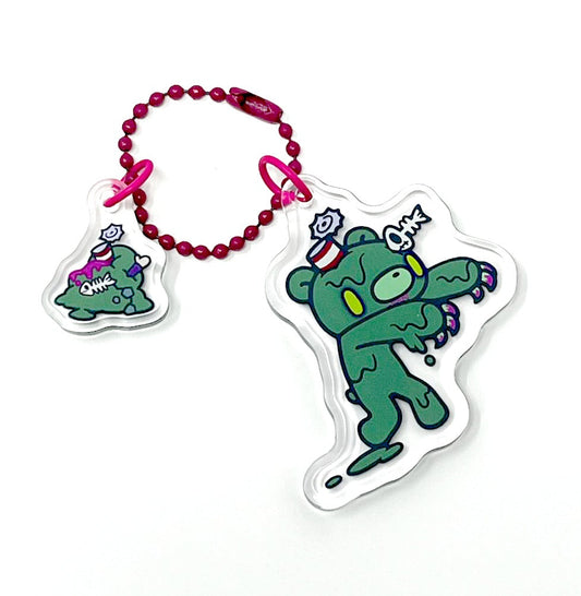 Two green cartoon character keychains on a white background