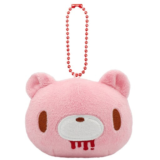 Pink plush keychain with a face design on a white background